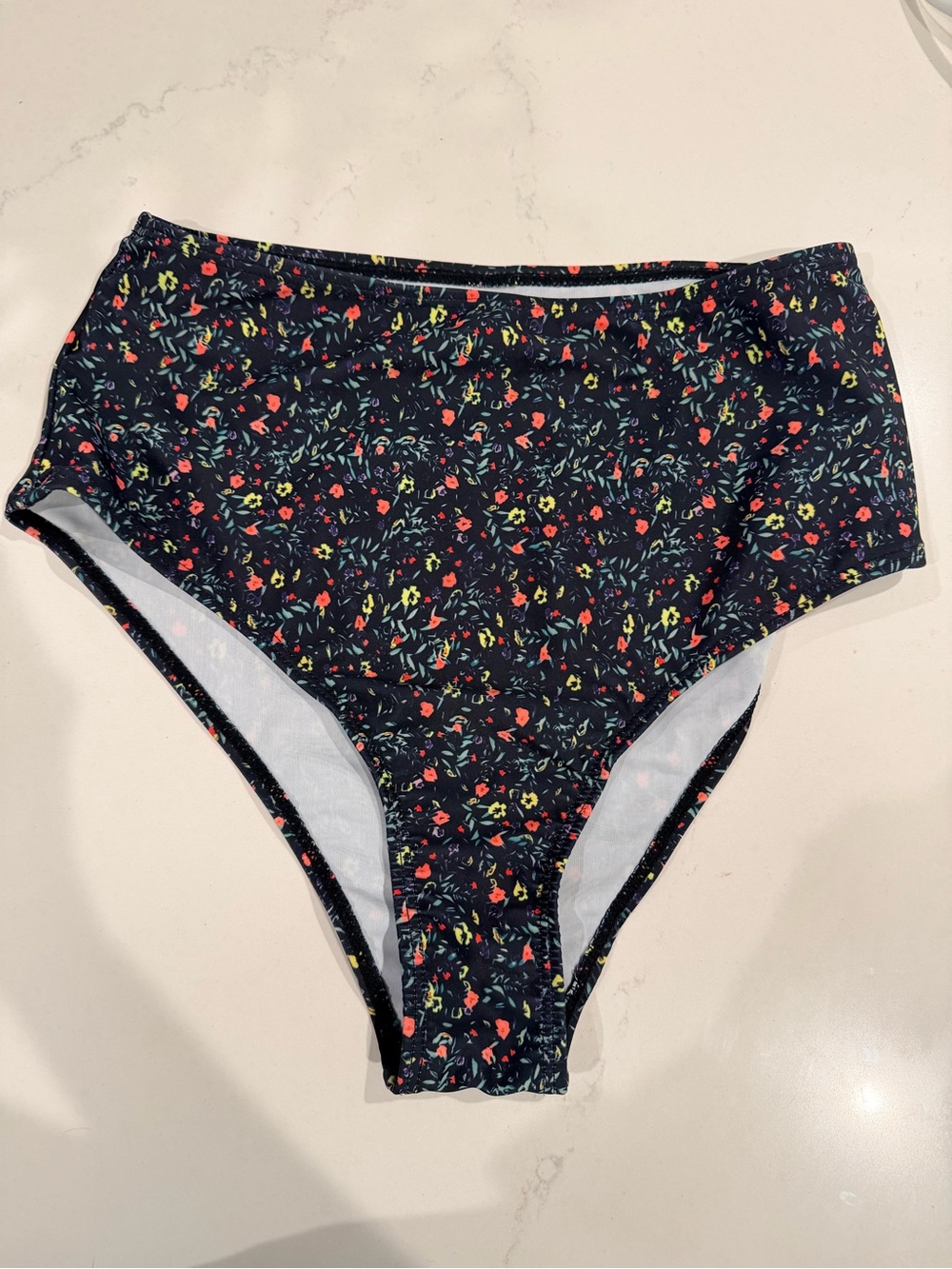High-Waisted Floral Bikini Bottoms - black with bright color Flowers.